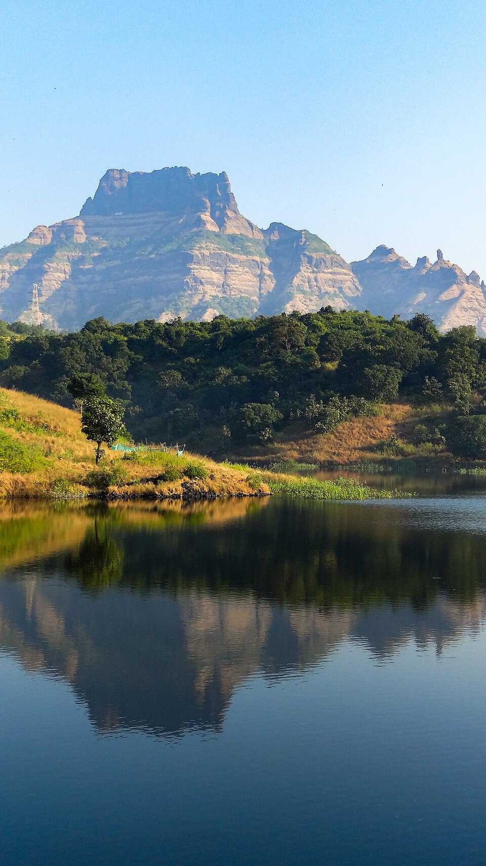 Mountain reflections across the reservoir near Gadeshwar Dam